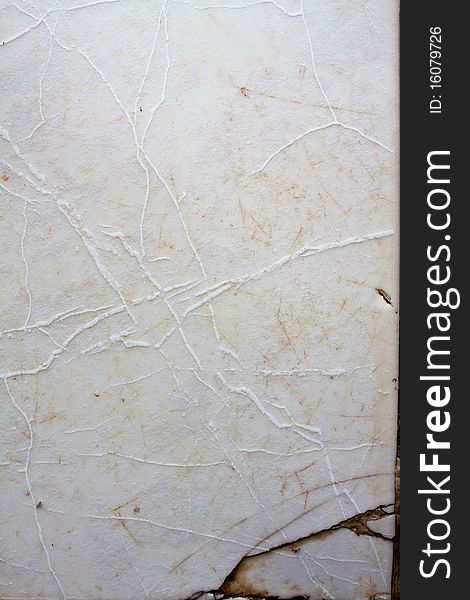 Detail of a white cracked marble surface. Detail of a white cracked marble surface