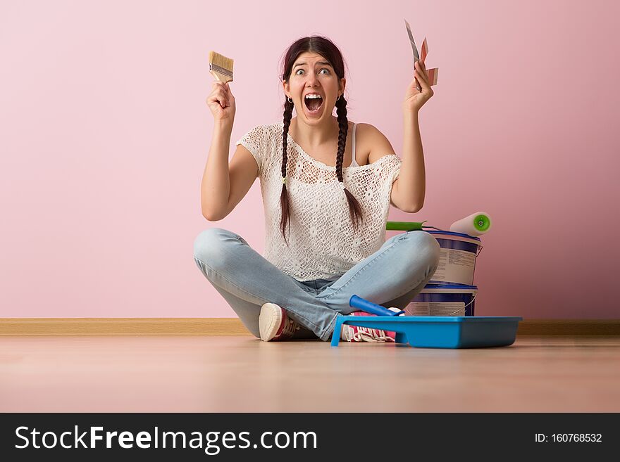 Woman With Brush And Color Palette Sitting On The Floor