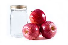 Three Gala Apples Beside A Mason Canning Jar Royalty Free Stock Image
