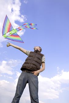 Man Playing With Multicolored Kite Royalty Free Stock Images