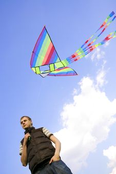 Man Playing With Multicolored Kite Stock Photography