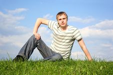 Man Siting On Summer Lawn, Hand On Knee Royalty Free Stock Photography Man Siting On Summer Lawn, Hand On Knee Royalty Free Stock Photography