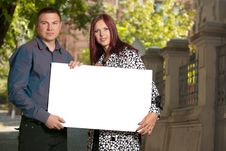 Young Couple With Blank Board Royalty Free Stock Photos Young Couple With Blank Board Royalty Free Stock Photos