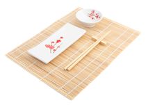 Sushi Plates And Chopsticks On Bamboo Mat Stock Image