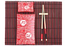 Sushi Plates And Chopsticks On Bamboo Mat Stock Photo