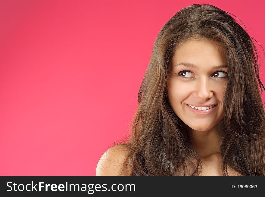 Young beautiful woman with long hair posing on vivid background. Young beautiful woman with long hair posing on vivid background