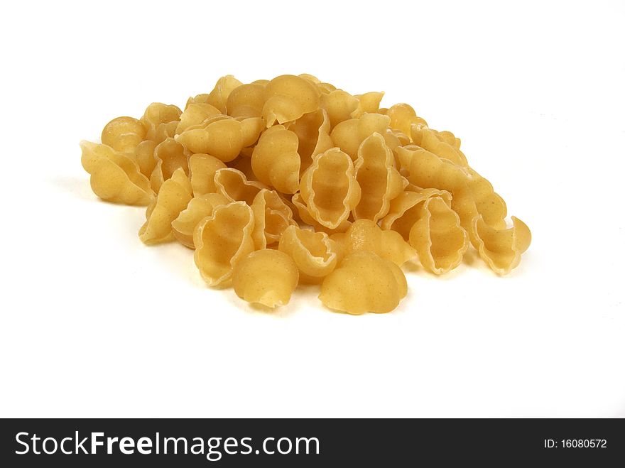 Uncoocked pasta shells also know as conchiglie, on a white background. Uncoocked pasta shells also know as conchiglie, on a white background