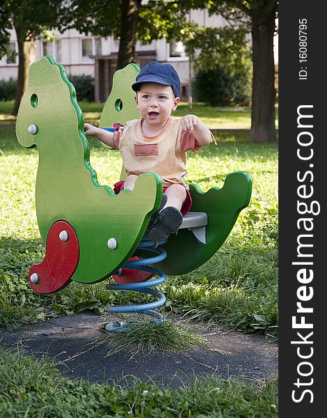 Portrait of a small child boy on the outdoor playground toy. Portrait of a small child boy on the outdoor playground toy.