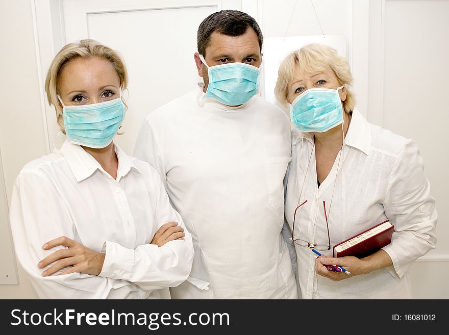 Three doctors  in uniform.Front view. Three doctors  in uniform.Front view