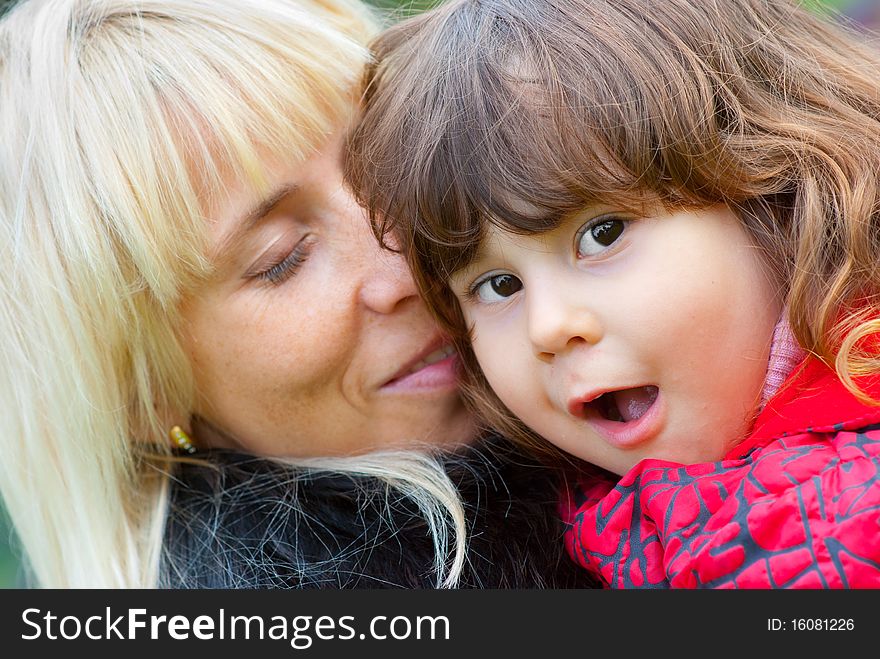 Happy mother and daughter portrait together outdoors