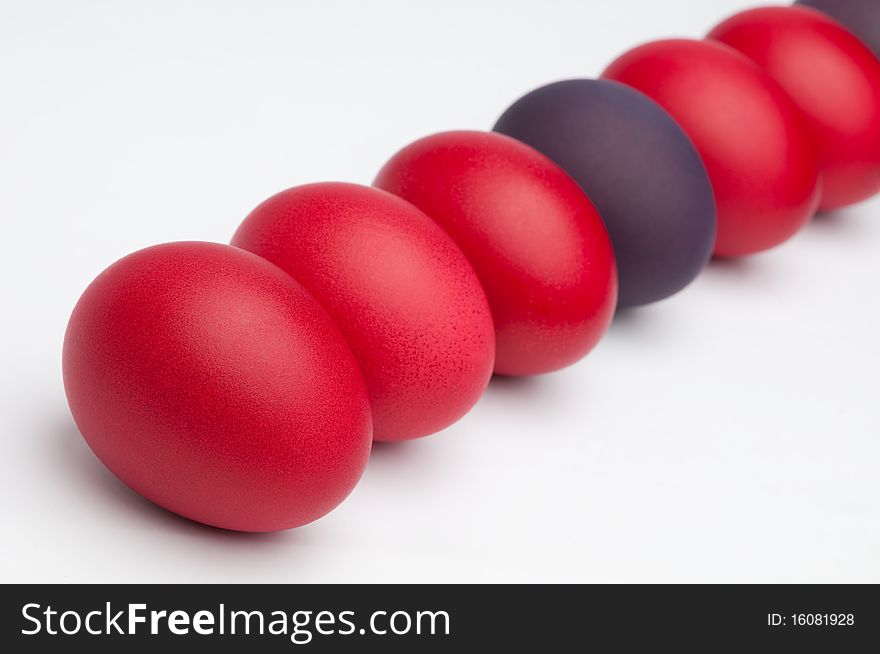 Red and violet Easter eggs on an white background.