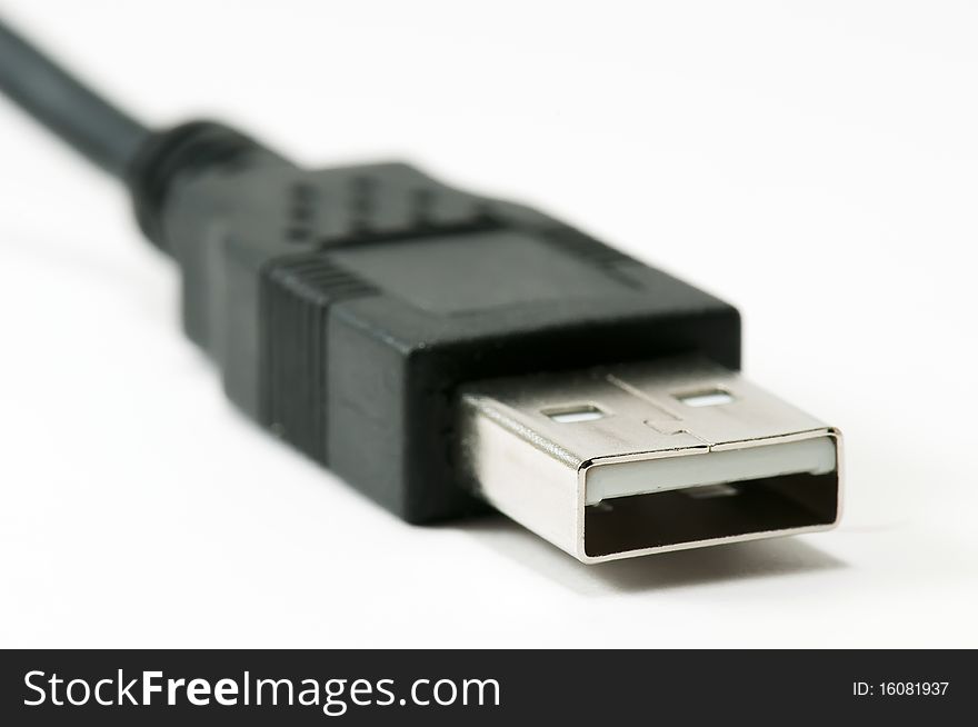 Close-up image of a USB connector with cable leading away into the background. Close-up image of a USB connector with cable leading away into the background