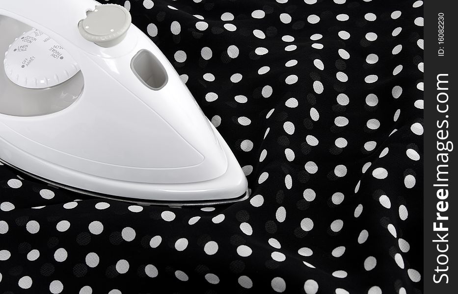 Ironing delicate black and white polka fabric. Ironing delicate black and white polka fabric.