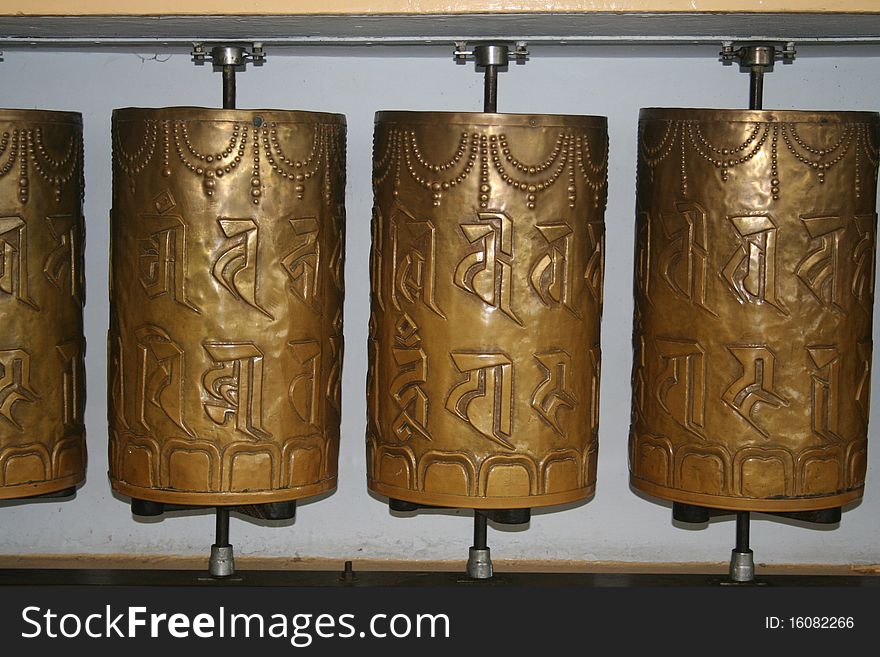 Buddist prayer wheels in bright red with mantra written all over. Buddist prayer wheels in bright red with mantra written all over