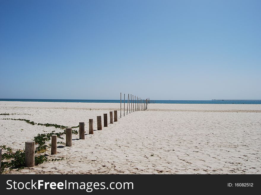 Beach in oman with some poles