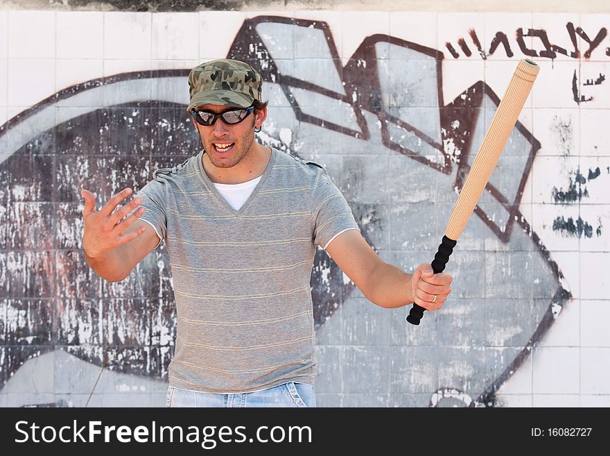 Aggressive Man With A Stick In A Hand
