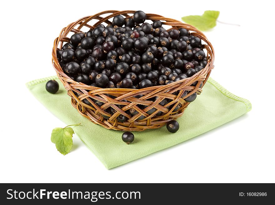 Basket of black currant isolated on white