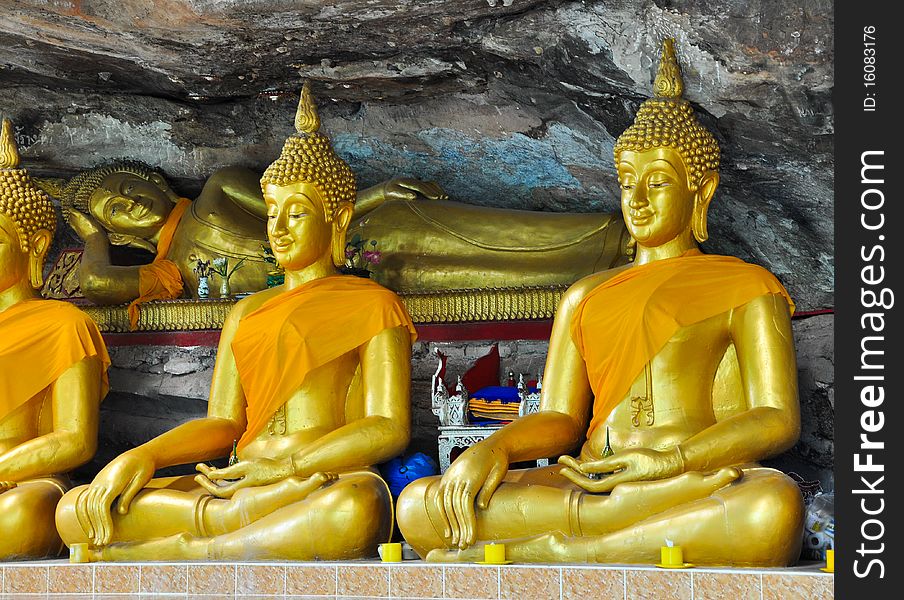 Gold Buddha in the cave and stone background of temple Thailand. Gold Buddha in the cave and stone background of temple Thailand