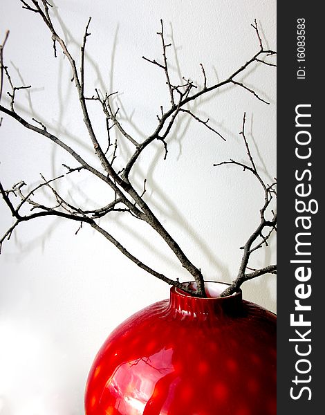 A twig in a red vase