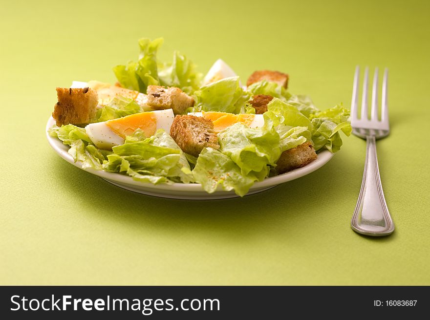 Salad with eggs on green background. Salad with eggs on green background