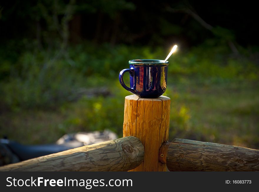 A cup of hot chocolate sitting on the porch.