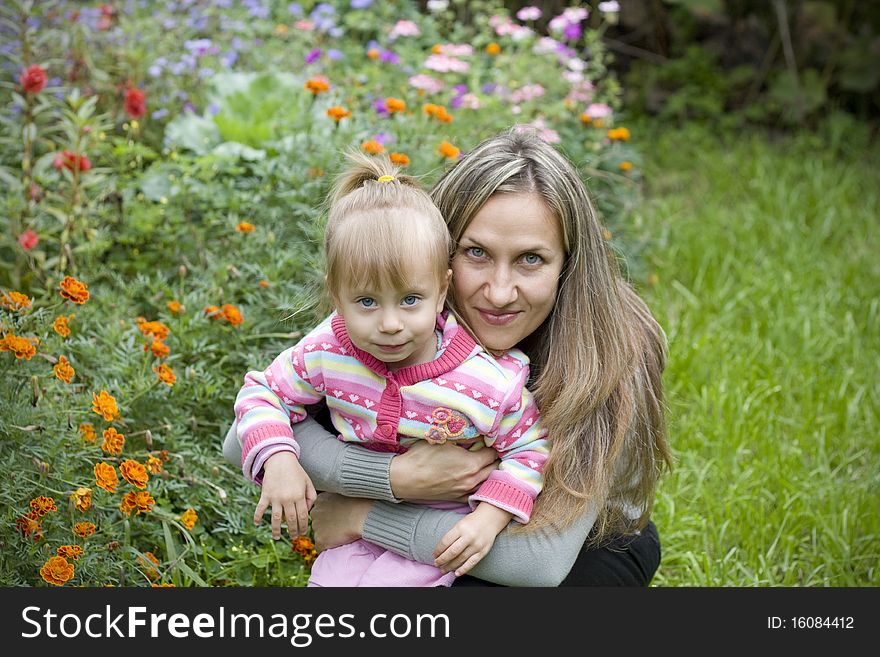 Girl With Her Mother In The Garden