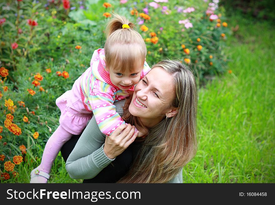 Girl With Her Mother In The Garden