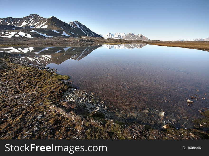 Arctic summer landscape - mountains, tundra, water. Arctic summer landscape - mountains, tundra, water