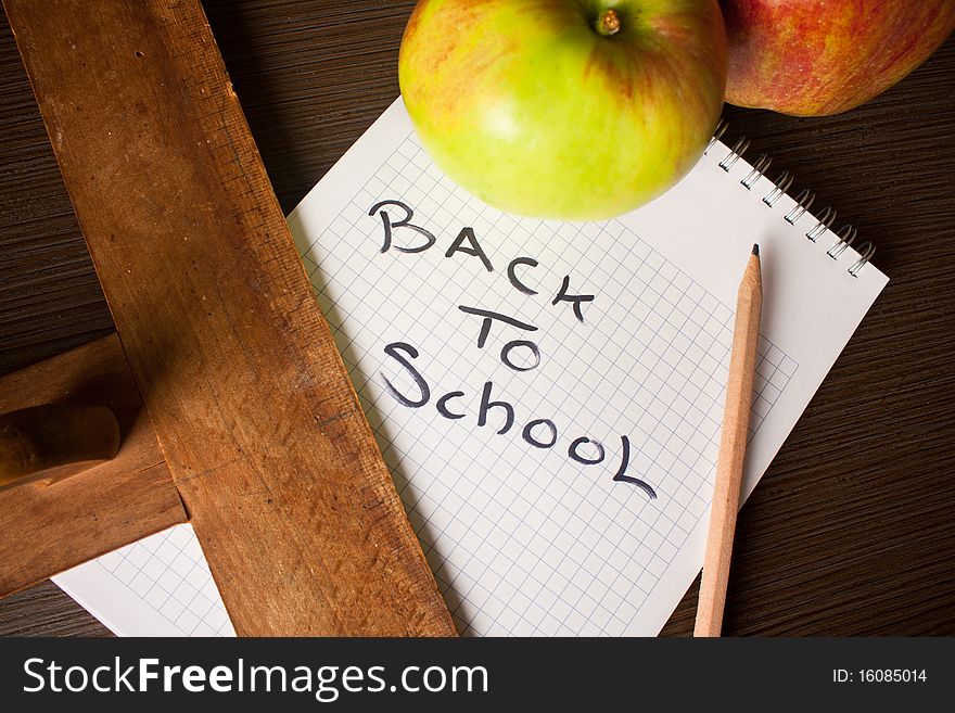 Spiral notebook with apples on table. Spiral notebook with apples on table