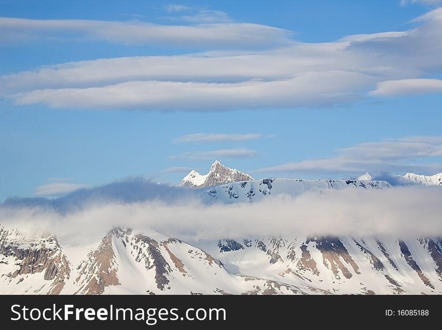 Mountain landscape - high mountains in clouds