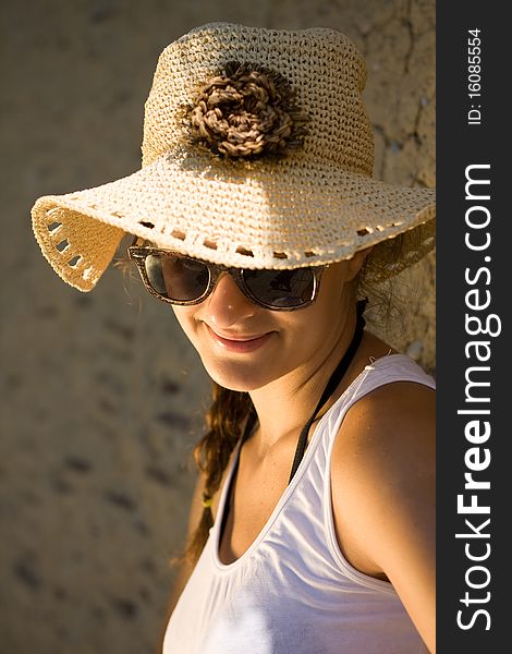 Happy young girl in white tank top at the beach