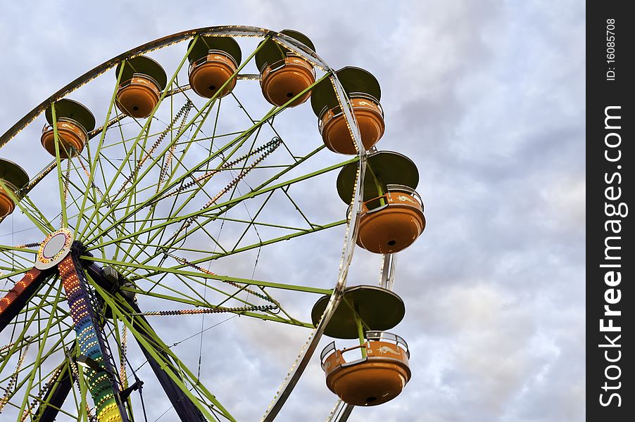 A Freeis Wheel at a county fair against a colorful evening sky. A Freeis Wheel at a county fair against a colorful evening sky.