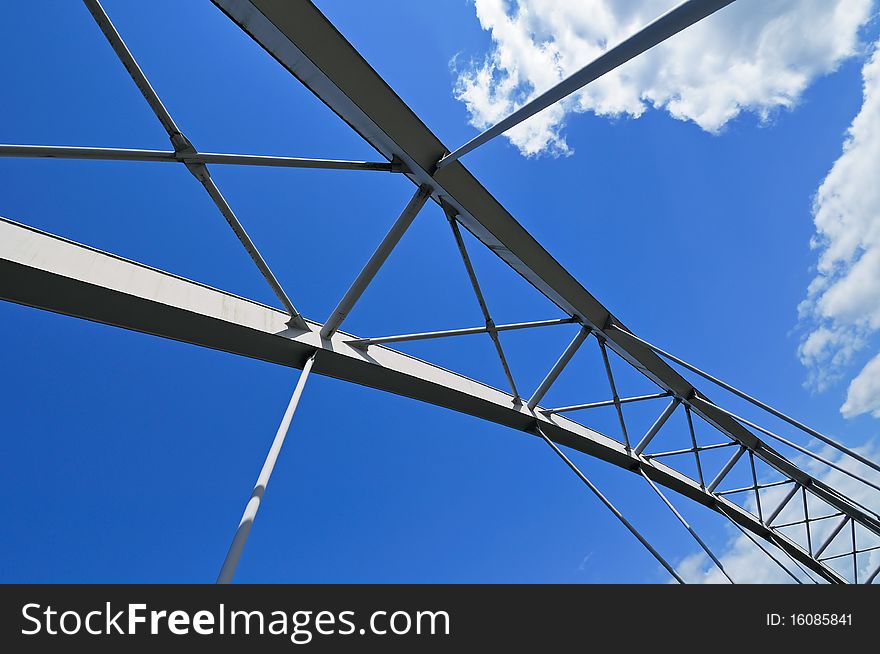 Modern Tied Arch Bridge Against Cloudy Blue Sky