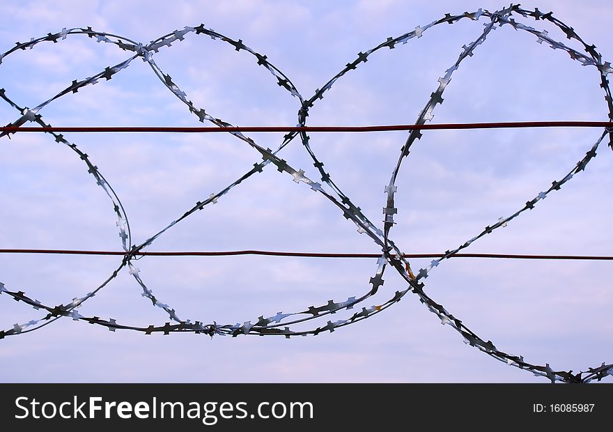 Barbed wire against the sky