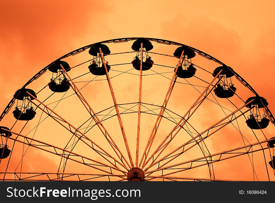 Ferris wheel on a sunset sky