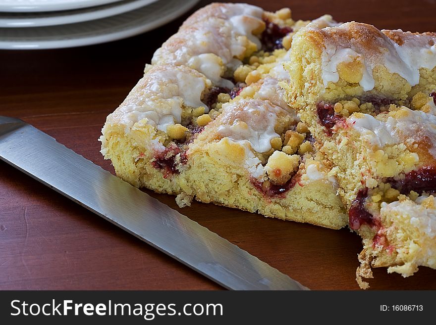 Fruit Danish being cut and served for breakfast. Fruit Danish being cut and served for breakfast.