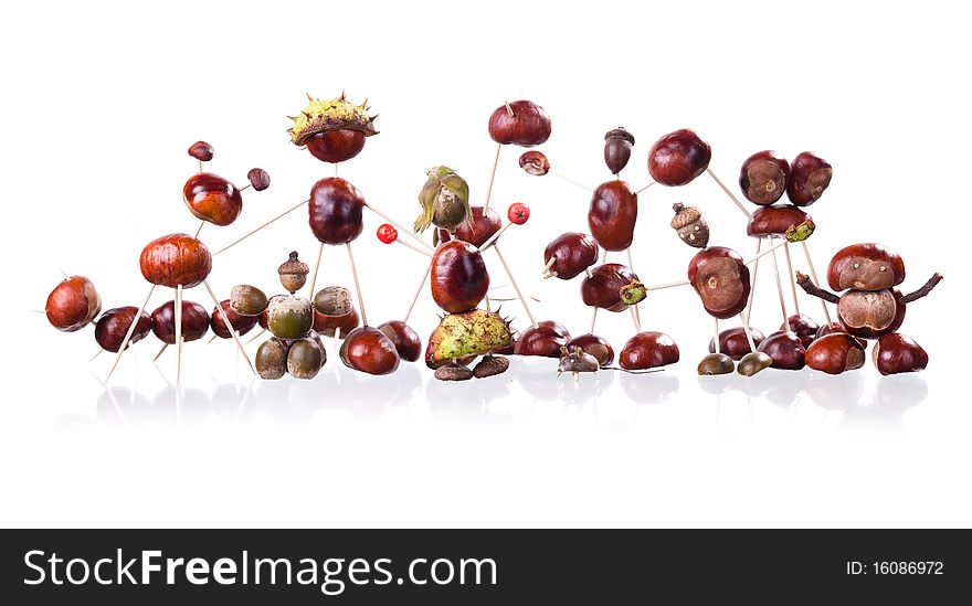 Group of little manikin made of chestnuts isolated on white. Group of little manikin made of chestnuts isolated on white