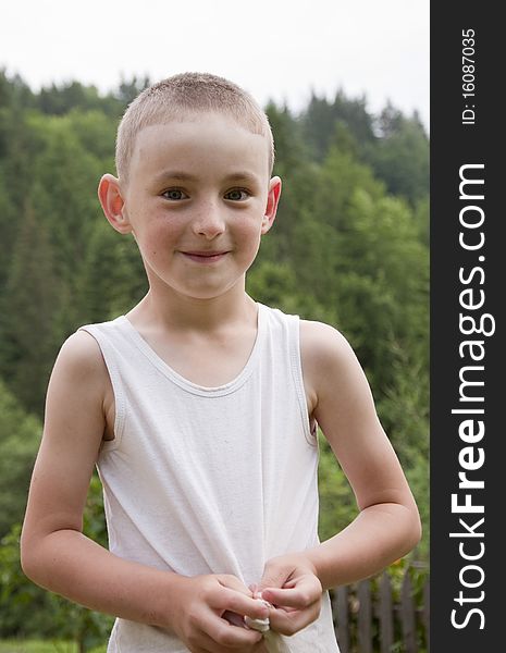 Boy in shirt on a background the forest