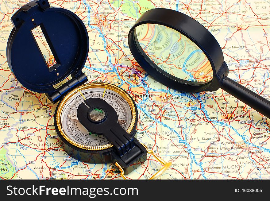 Compass and magnifier on a map for travel by close up. Compass and magnifier on a map for travel by close up