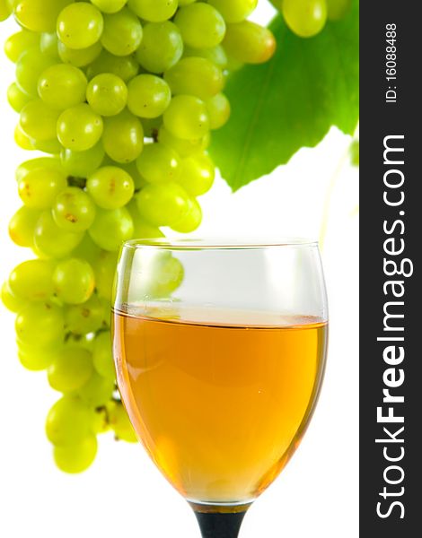 Glass of wine and grapes on a white background