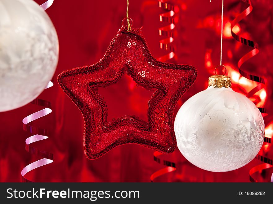 Beautiful christmas star and white baubles. Focus on star