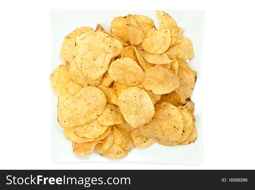 Heap of chips on plate isolated on white background