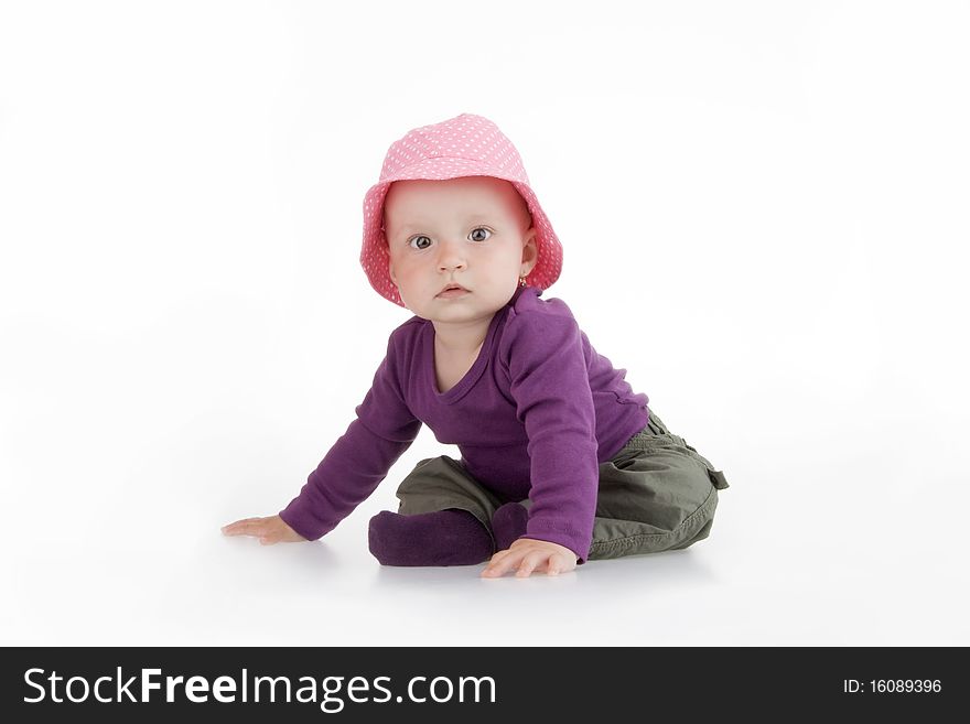 Infant sitting on white background.