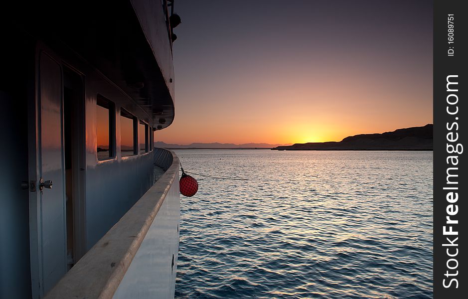 Sunset over the sea reflected in the windows of a boat. Sunset over the sea reflected in the windows of a boat