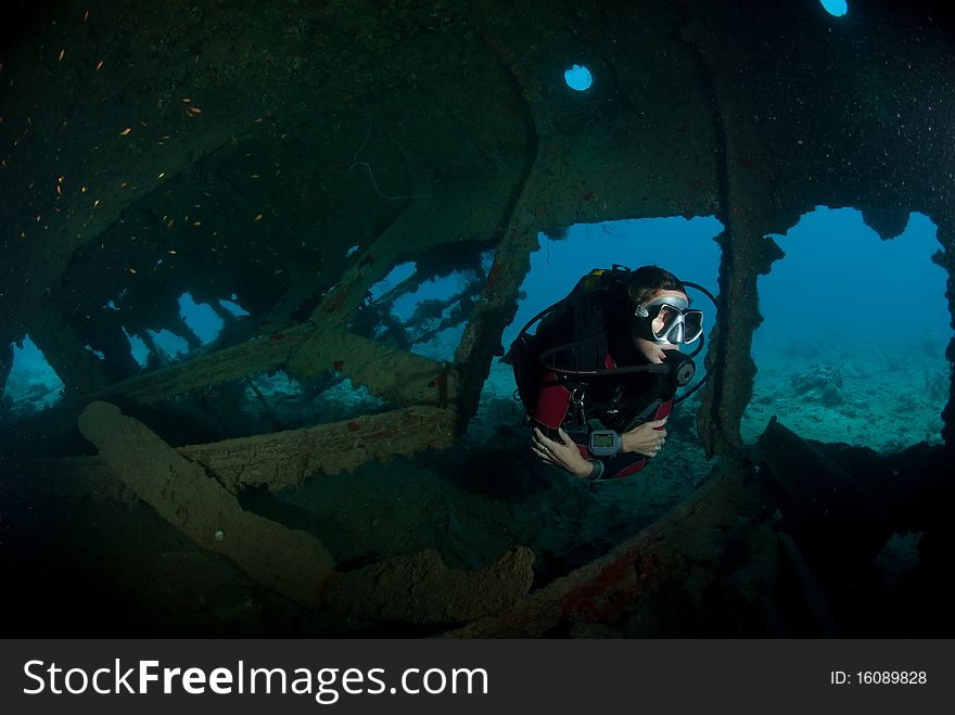 A female scuba diver exploring the inside of the SS Dunraven shipwreck. Beacon rock, Ras Mohammed national Park, Red Sea, Egypt. A female scuba diver exploring the inside of the SS Dunraven shipwreck. Beacon rock, Ras Mohammed national Park, Red Sea, Egypt.