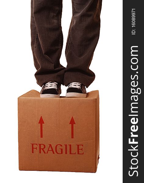 A concept image of a man standing on a box labelled fragile. A concept image of a man standing on a box labelled fragile