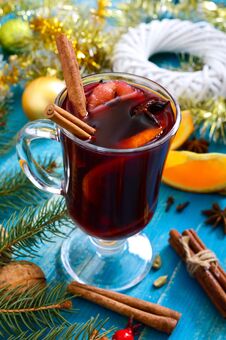 Christmas Mulled Red Wine With Spices And Fruits On A Blue Wooden Rustic Table. Traditional Hot Drink With Cinnamon, Cardamom, Royalty Free Stock Images
