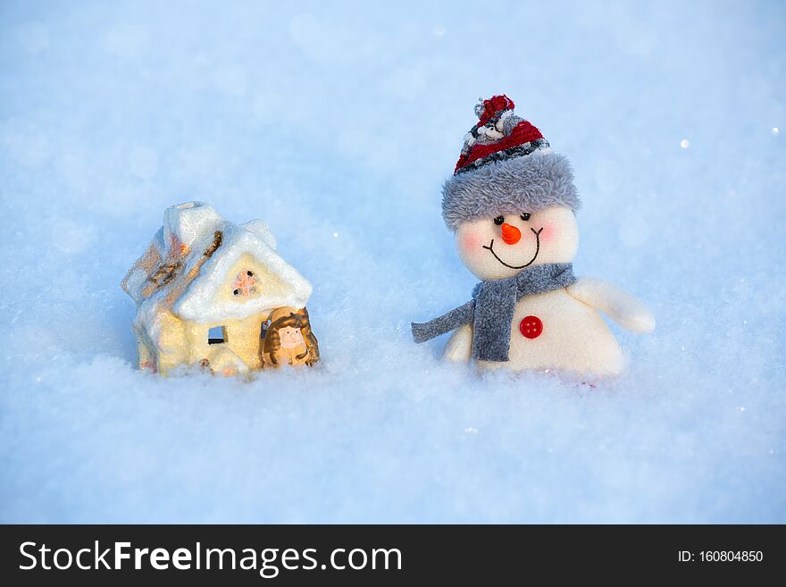 Happy funny toy snowman standing on the snow