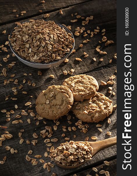 Homemade cookies with whole grain oatmeal and spoon on rustic wooden table