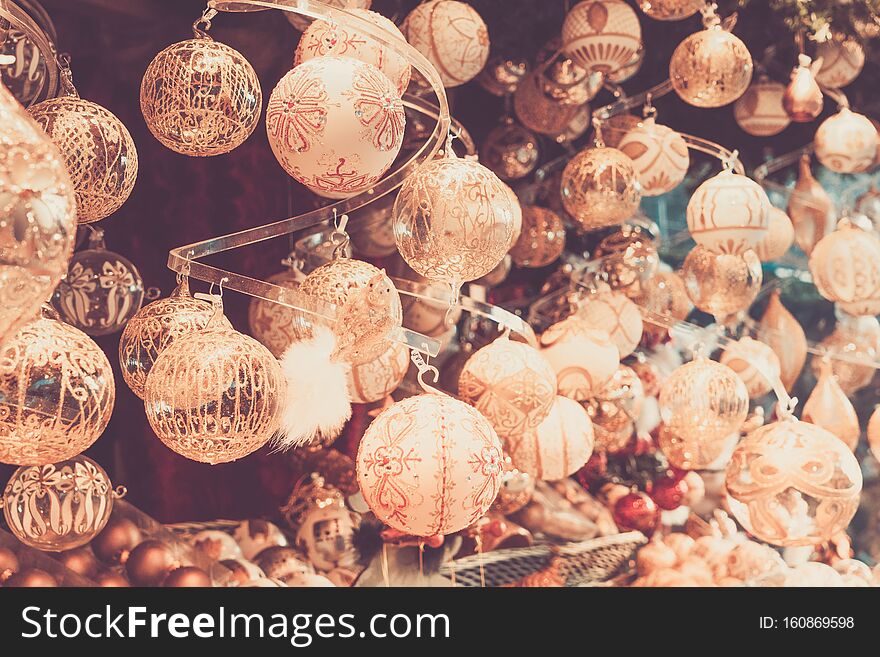 Christmas market kiosk details with wide choice of christmas golden tree decorations, retro toned